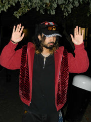 Rabiun customer in a red jacket wearing the Rabiun hat, arms raised